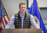 Representative Daudt stands behind a podium and speaks to someone out of view.